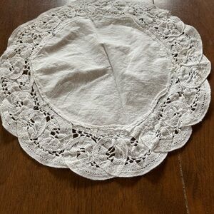 Vintage white fabric doily with lace trim.